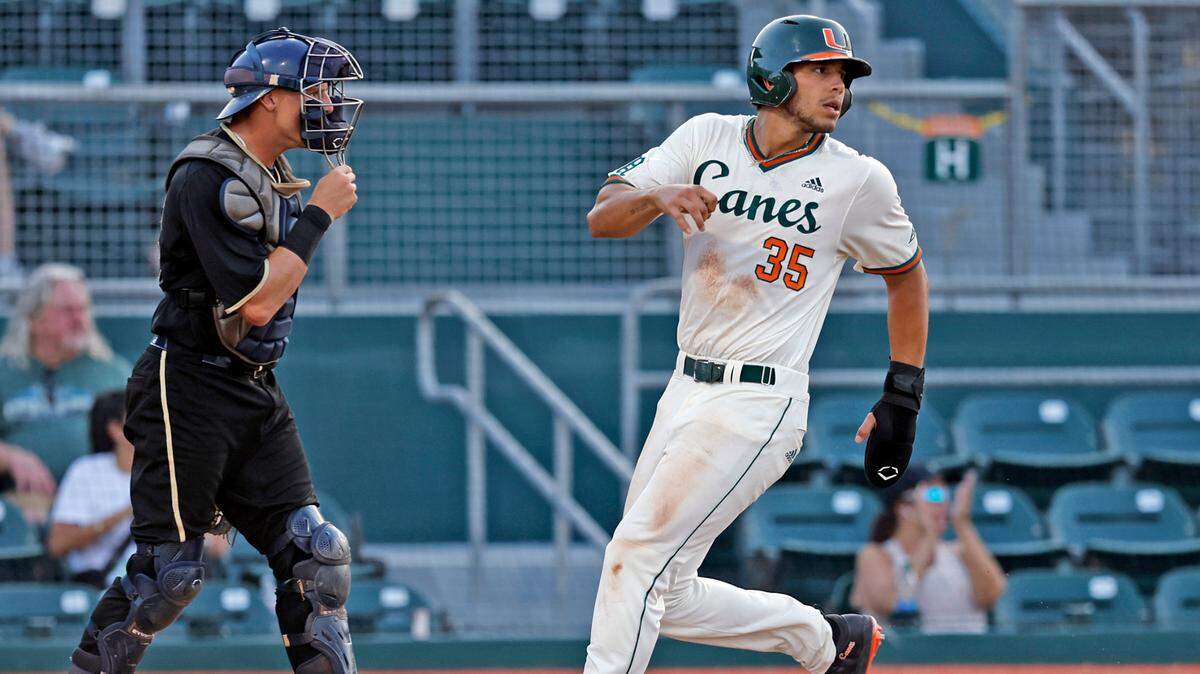 Miami Hurricanes infielder Yohandy Morales (35) scores after a hit by Miami Hurricanes infielder Blake Cyr (4) in the sixth inning against the Florida International University at the University of Miami’s Mark Light Field at Alex Rodriguez Park in Coral Gables on Wednesday, May 10, 2023.