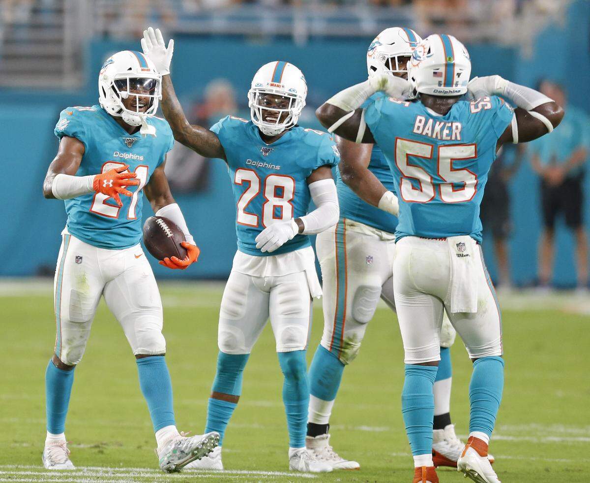 Miami Dolphins cornerback Eric Rowe (21) celebrates a turnover with teammates in the first quarter as the Miami Dolphins host the Jacksonville Jaguars at Hard Rock Stadium on Thursday, August 22, 2019.