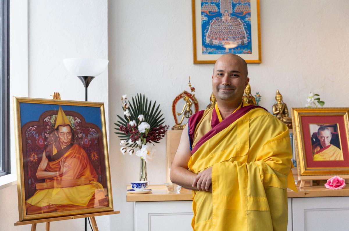 Gen Kelsang Tashi a resident teacher at Kadampa Meditation Center Miami, stands next to a portrait, on Friday, June 27, 2025, in Miami, Florida.