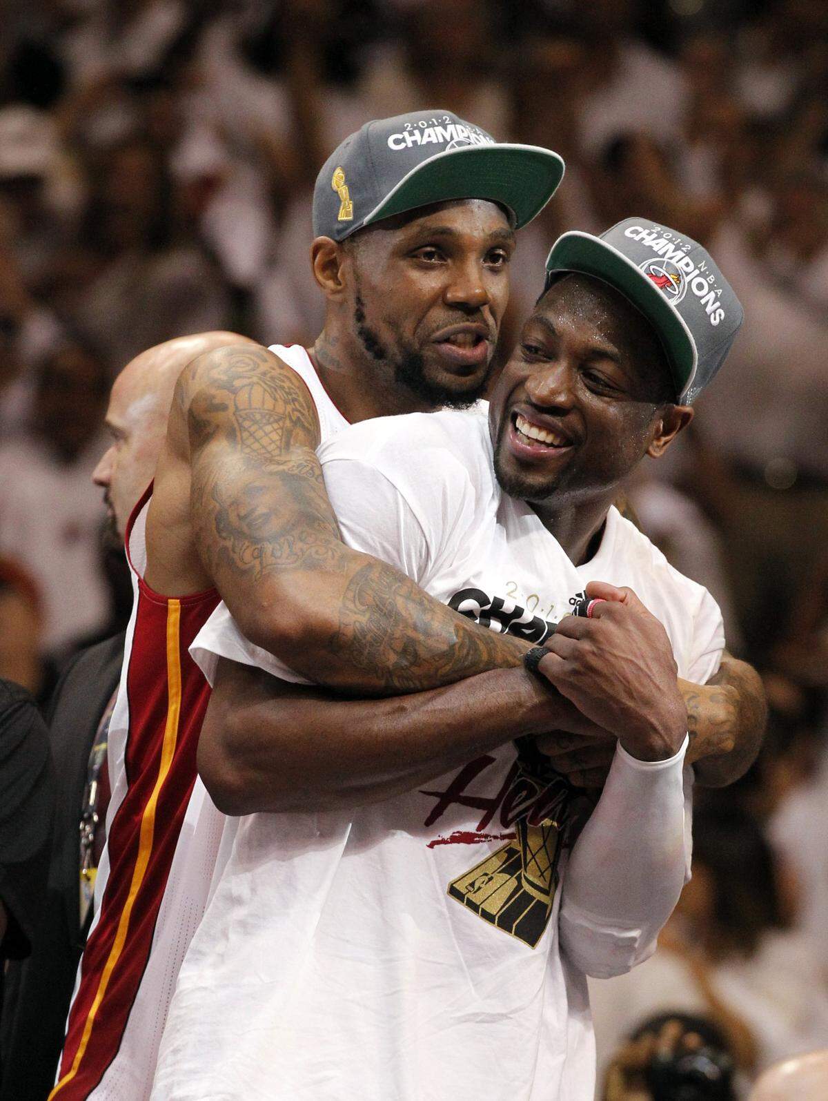 Miami Heat’s Udonis Haslem and Dwyane Wade celebrate in the final seconds of the victory over the Oklahoma City Thunder’s in Game 5 of the NBA Finals at the AmericanAirlines Arena in Miami, Florida, June 21, 2012.
