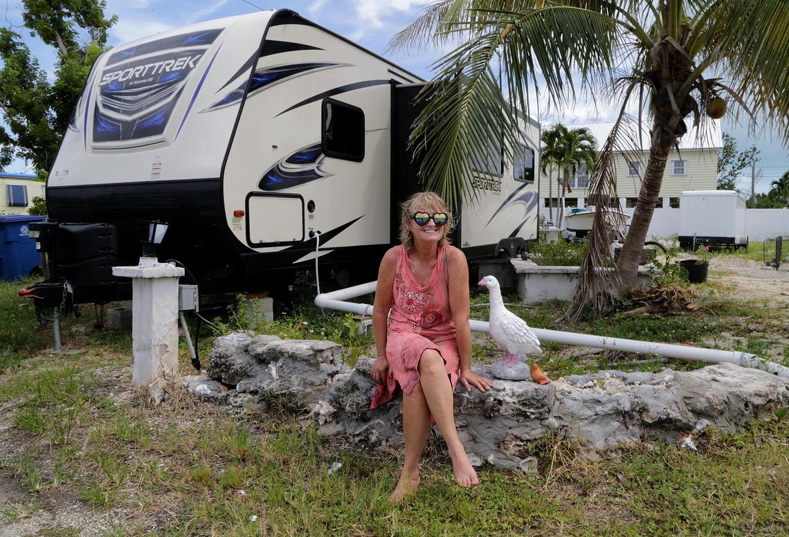 Christine King sits in front of her FEMA-issued mobile home on Aug. 29, 2018, a year after losing her own mobile home in Big Pine Key to Hurricane Irma. Many one-time Keys residents have simply left the island chain.