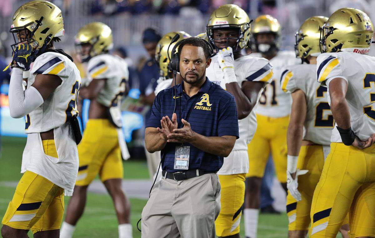 St. Thomas Aquinas coach Roger Harriott with players as the Raiders play Tampa Bay Tech in the FHSAA Class 7A State Championship at DRV PNK Stadium, in Fort Lauderdale on Friday, Dec. 17, 2021.