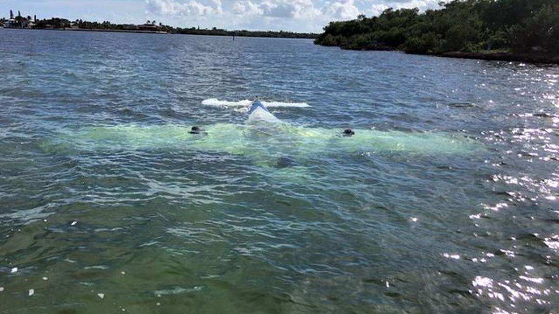 An upside down plane rests on the bottom of shallow water in the Gulf of Mexico off the Middle Florida Keys city of Marathon Friday, Aug. 19, 2022. Two people were safely rescued from the water.