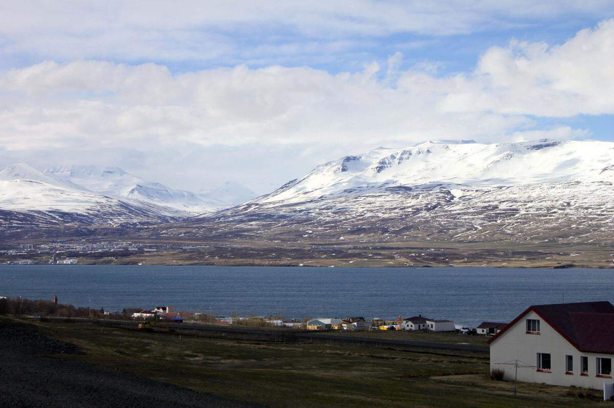 Several homes and farms in Akureyri overlook the blue Eyjafjordur fjord, the longest in Iceland and popular for whale-watching. 