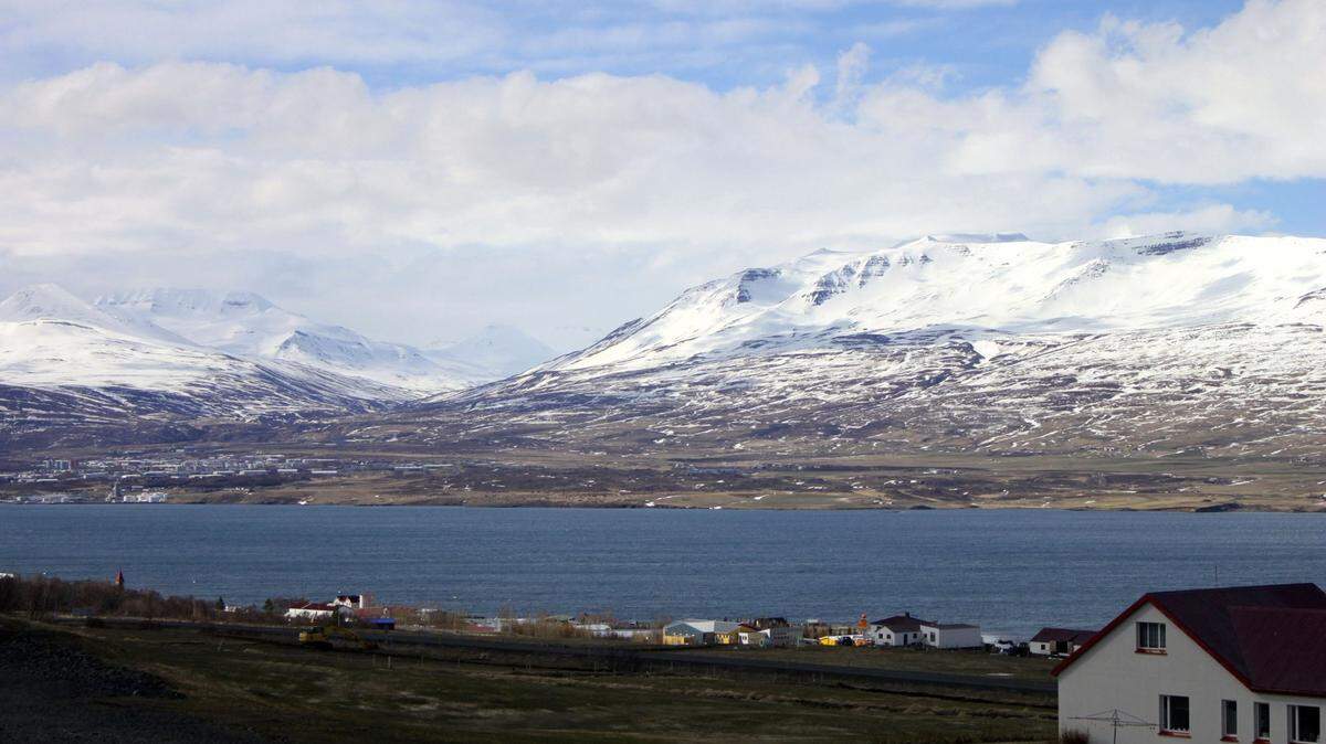 Several homes and farms in Akureyri overlook the blue Eyjafjordur fjord, the longest in Iceland and popular for whale-watching.