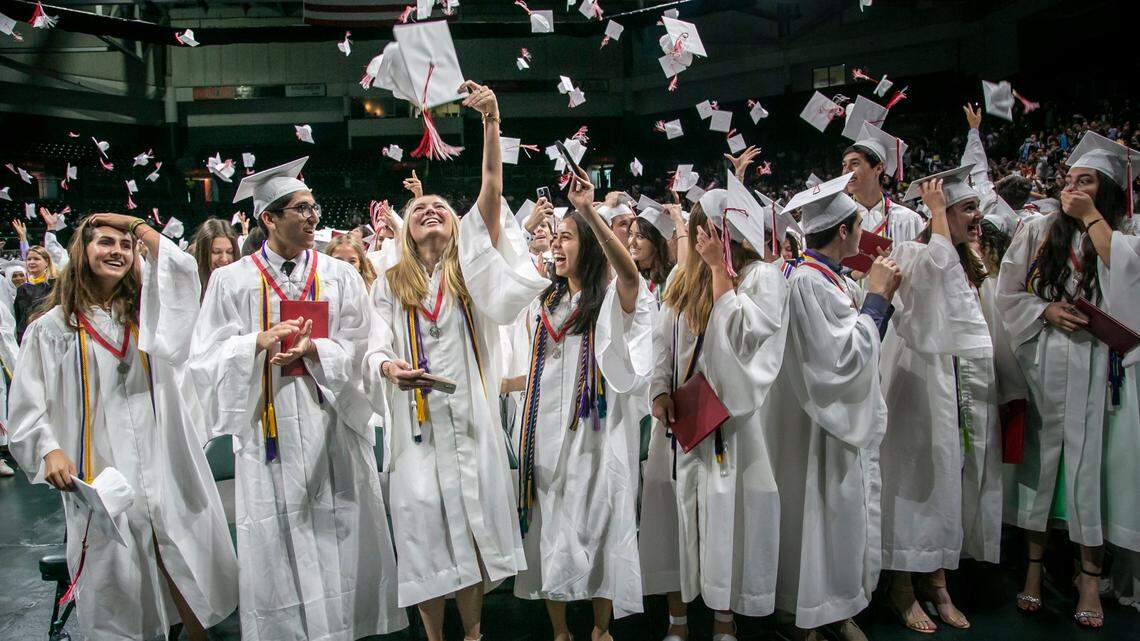 Coral Gables, June 1, 2022 - Graduates of Miami Beach Senior High toss their caps in the air after receiving their diplomas. On Thursday, March 16, 2023, the Miami-Dade and Broward school districts announced the graduation dates and venues for high school seniors.