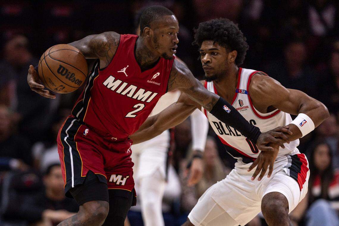 Miami Heat guard Terry Rozier (2) dribbles while defended by Portland Trail Blazers guard Scoot Henderson (00) during the first half of an NBA game at Kaseya Center on January 21, 2025, in Miami.