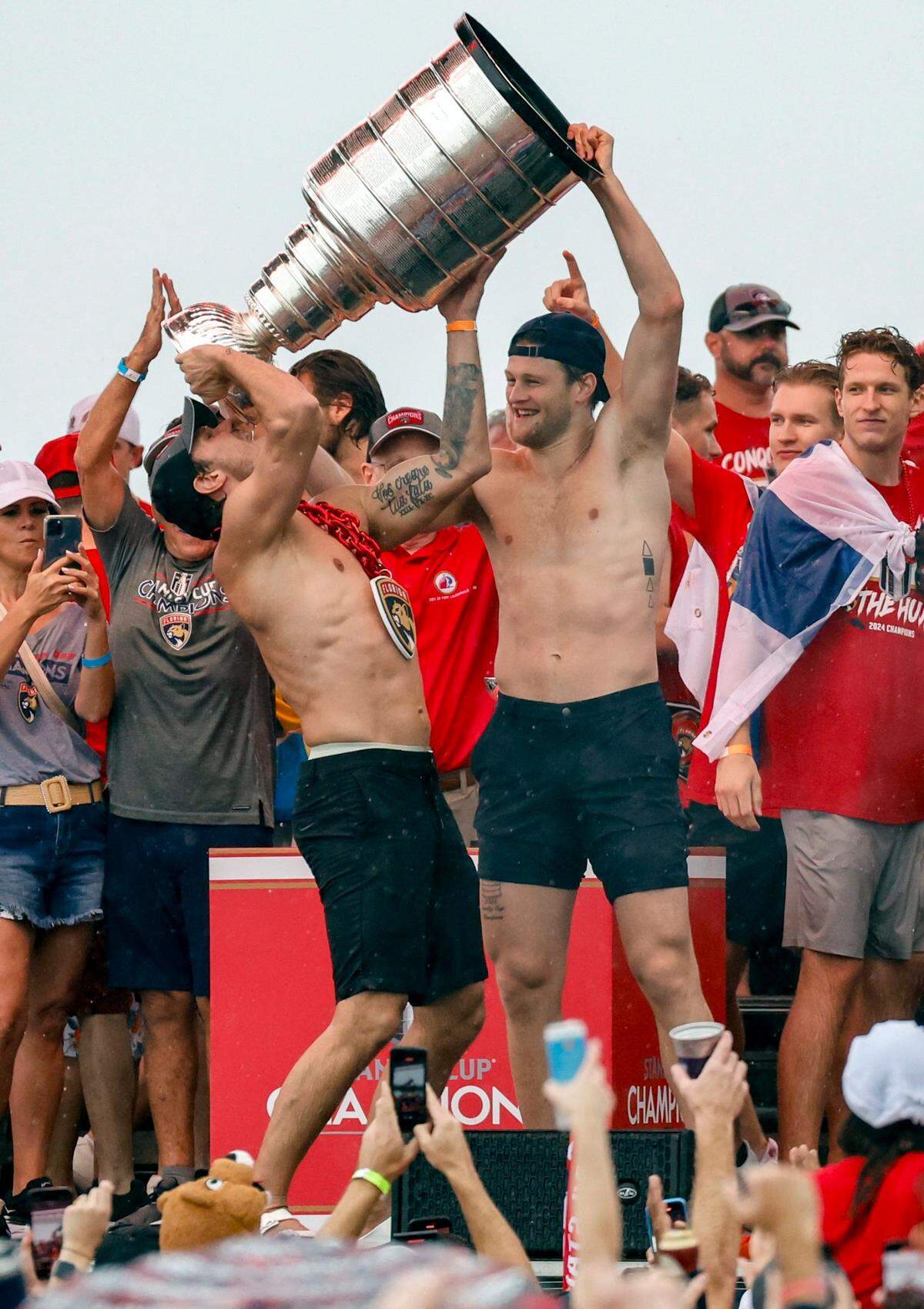 Florida Panthers center Steven Lorentz (18) helps Florida Panthers right wing Vladimir Tarasenko (10) drink out of the Stanley Cup during the Florida Panthers Stanley Cup victory rally along A1A in Fort Lauderdale, Florida on Sunday, June 30, 2024. 