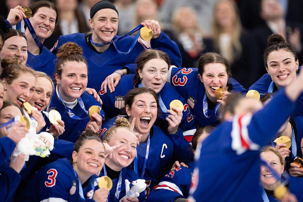 MILAN, ITALY - FEBRUARY 19: Megan Keller #5 of Team United States takes a victory selfie with her teammates after the medal ceremony for the Ice Hockey Women following the Women's Gold Medal match between the United States and Canada on day 13 of the Milano Cortina 2026 Winter Olympic games at Milano Santagiulia Ice Hockey Arena on February 19, 2026 in Milan, Italy. ( (Photo by Andreas Rentz/Getty Images)