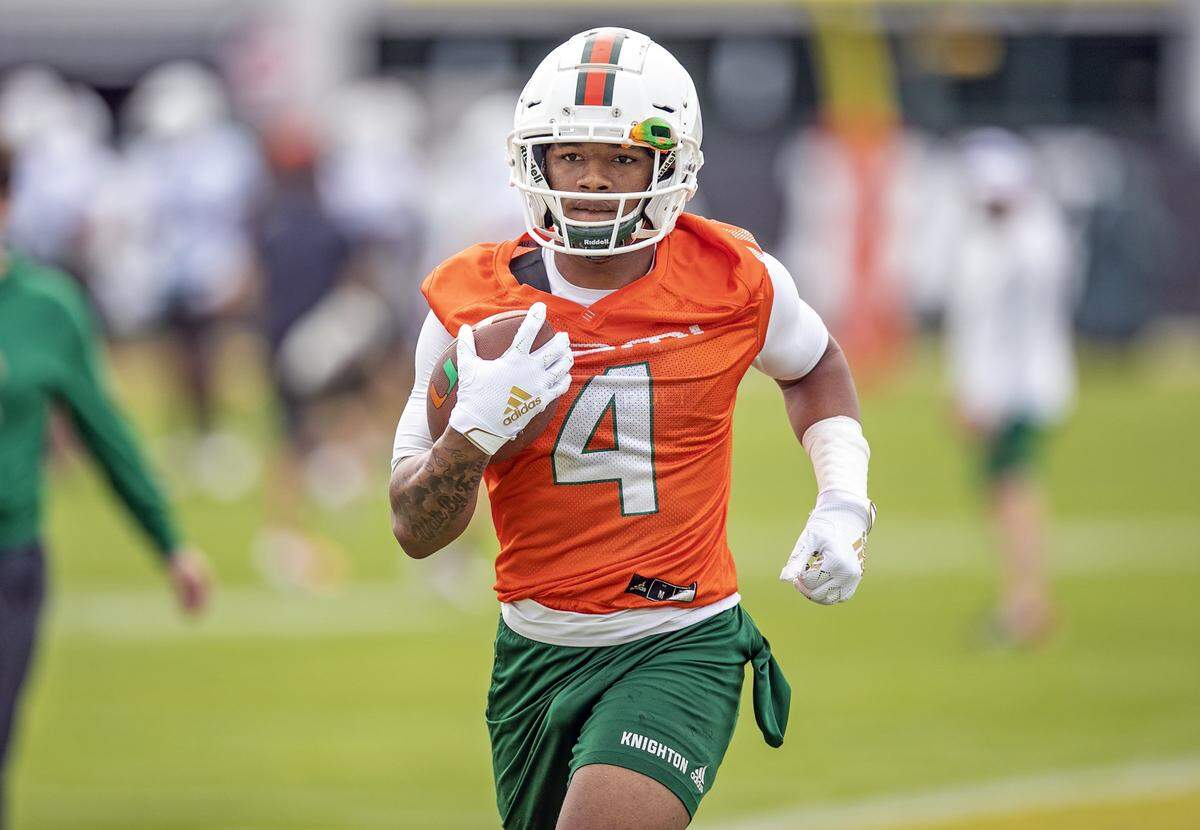 Miami Hurricanes running back Jaylan Knighton (4) runs through practice drills at the University of Miami’s Greentree Field in Coral Gables on Tuesday, March 3, 2020.