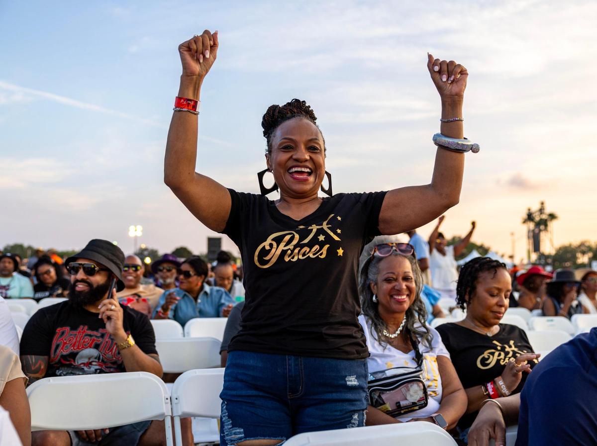 North Carolina native Trudie Bennett, 59, dances to the music as she celebrates her birthday during Jazz in the Gardens at Hard Rock Stadium Arena in Miami Gardens, Florida, on Saturday, March 9, 2024.