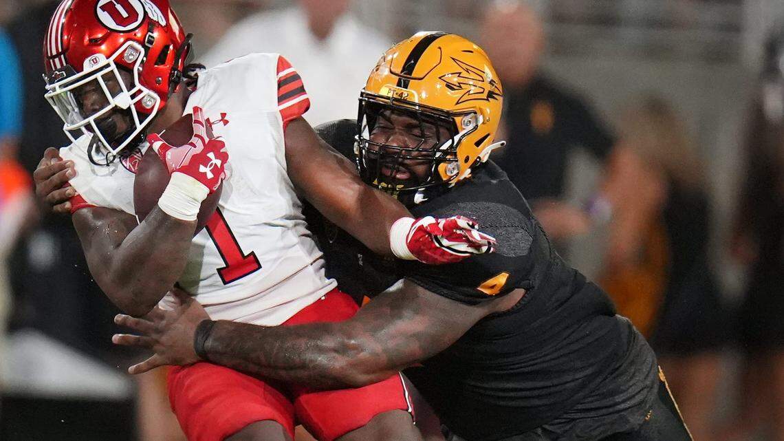 ASU defender Nesta Jade Silvera (4) drags down Utah’s Jaylon Glover (1) at Sun Devil Stadium on Saturday, Sept. 24, 2022. Football Utah Asu Utah At Asu