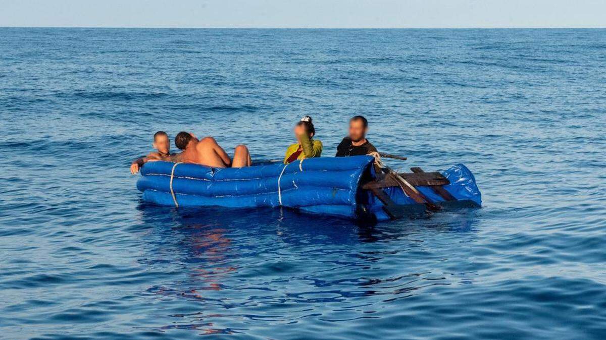 Four people sit on a makeshift migrant raft floating off Big Pine Key Dec. 21, 2022. Similar vessels are a common sight off the Florida Keys, which is the end point in the largest maritime exodus form Cuba in almost 10 years. The Coast Guard stopped a migrant boat with about 20 people on board Wednesday, Dec. 28, 2022.