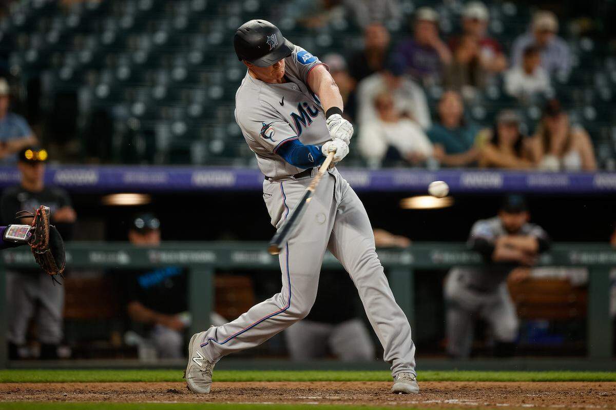 Miami Marlins pinch hitter Garrett Cooper (26) hits a two run home run in the ninth inning against the Colorado Rockies at Coors Field on Thursday, May 25, 2023.