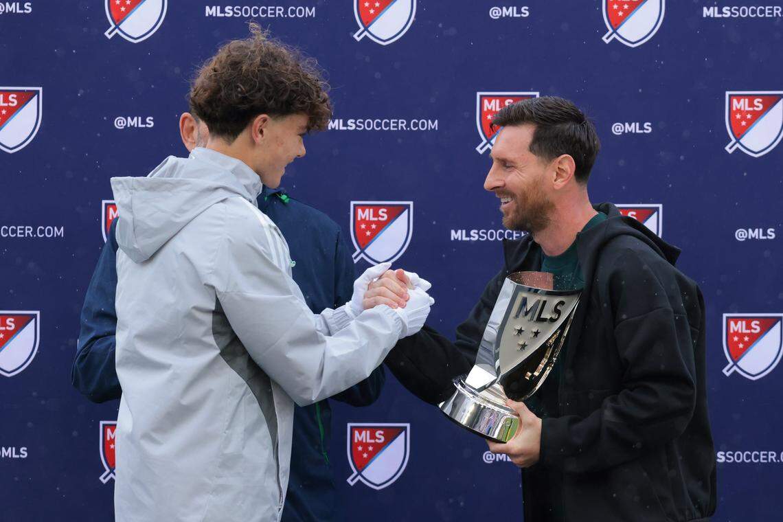 Inter Miami CF forward Lionel Messi receives the Landon Donovan MVP Award from Inter Miami CF U16 captain Nash Dearmin during a ceremony on Tuesday, Dec. 9, 2025, at Chase Stadium in Fort Lauderdale, Fla.