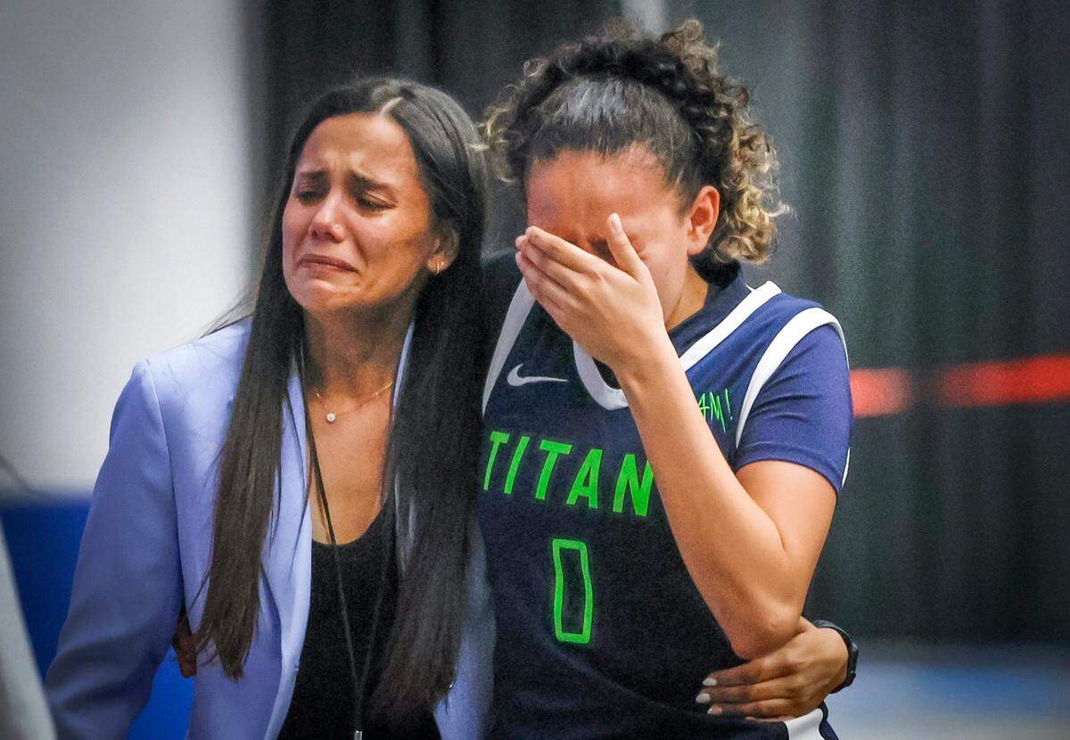 SLAM Miami Titans coach Krystal Cabrera walks off the court with Samantha Bautista (0) after the Titans are defeated by Cardinal Mooney during girls 3A basketball semifinal game of the Florida High School State Championships