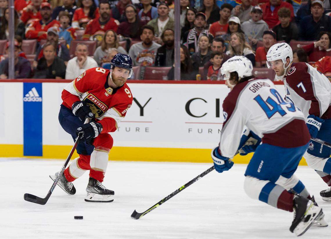 Florida Panthers center Sam Bennett (9) tries to pass the puck past Colorado Avalanche defenseman Samuel Girard (49) during the first period of an NHL game at the FLA Live Arena on Saturday, Feb. 11, 2023, in Sunrise, Fla.