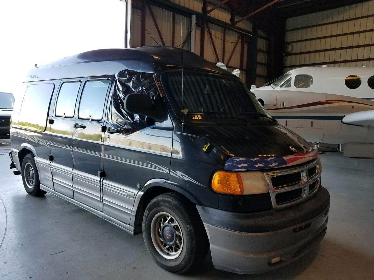The black Dodge conversion van belonging to Steven Wolf, who was arrested on a murder charge in the death of an unidentified woman on Nov. 21, 2018, sits inside the Monroe County Sheriff’s Office hangar in Marathon.