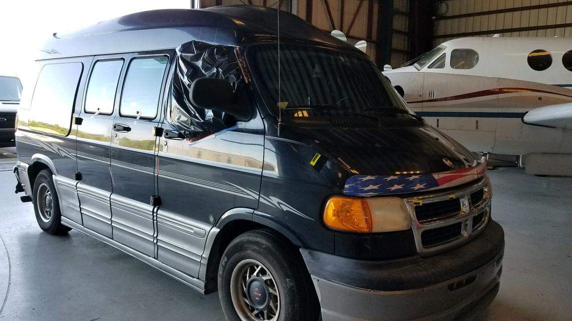 The black Dodge conversion van belonging to Steven Wolf, who was arrested on a murder charge in the death of an unidentified woman Wednesday, Nov. 21, sits inside the Monroe County Sheriff’s Office hangar in Marathon. Police are looking to speak with anyone who may have seen the van in Marathon between Tuesday morning and Wednesday evening.
