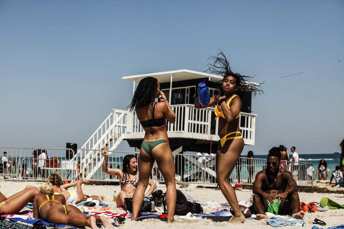 Alycia Pascual-Pena, right, dances to the Miami Beach Police DJ behind them on March 22, 2019. Miami Beach Police Department used their own DJ in South Beach as they began to toughen policing during spring break after outbreaks of fights and increased alcohol and drug consumption.