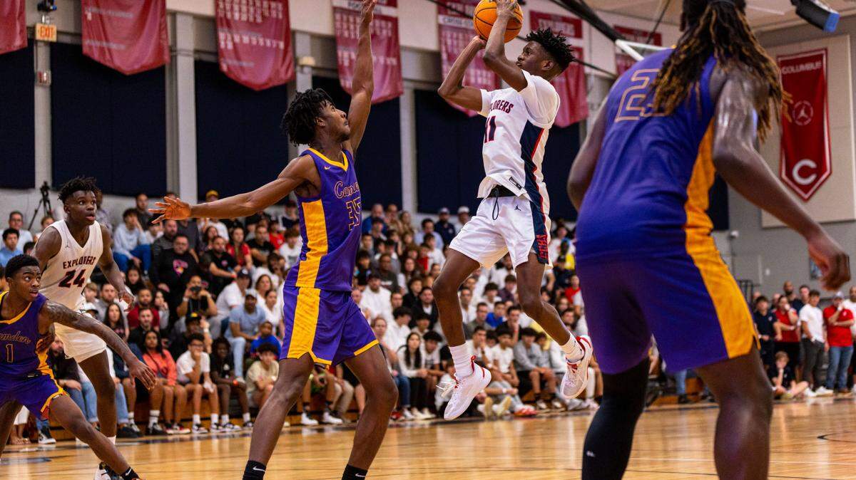 Explorers guard Garyn Bess (11) pulls up over Camden forward Dasear Haskins (35) during a high school basketball game at Christopher Columbus High School in Miami, Florida, on Wednesday, January 4, 2023.