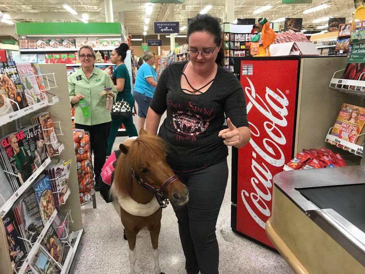 Jessica Wellman walks into a Publix for the first time with Honey, her service miniature horse, in November 2017.