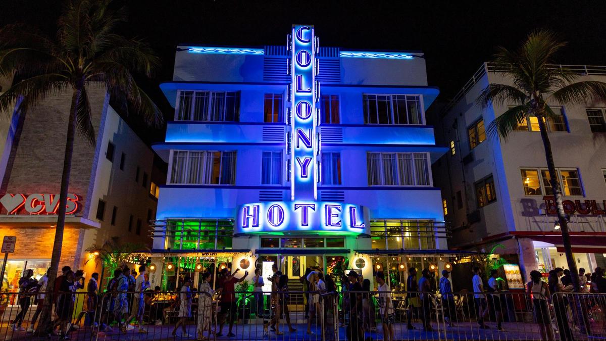 People walk past the Colony Hotel during spring break in Miami Beach on Friday, March 15, 2024.