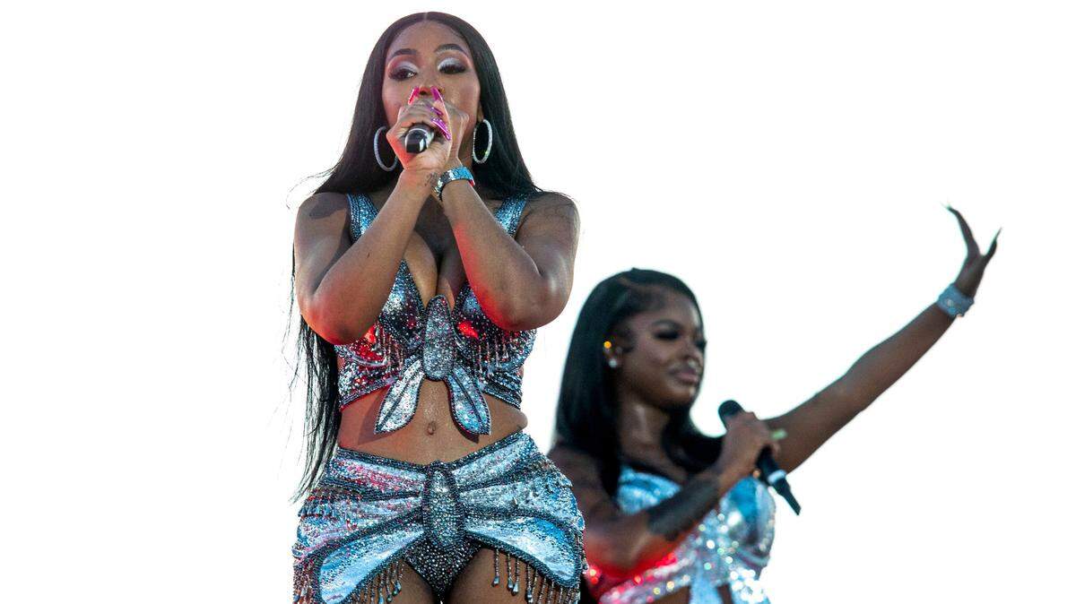 Yung Miami and JT from the City Girls hip hop duo react on stage during the second day of Rolling Loud Miami, an international hip-hop festival, at Hard Rock Stadium in Miami Gardens, Florida, on Saturday, July 23, 2022.