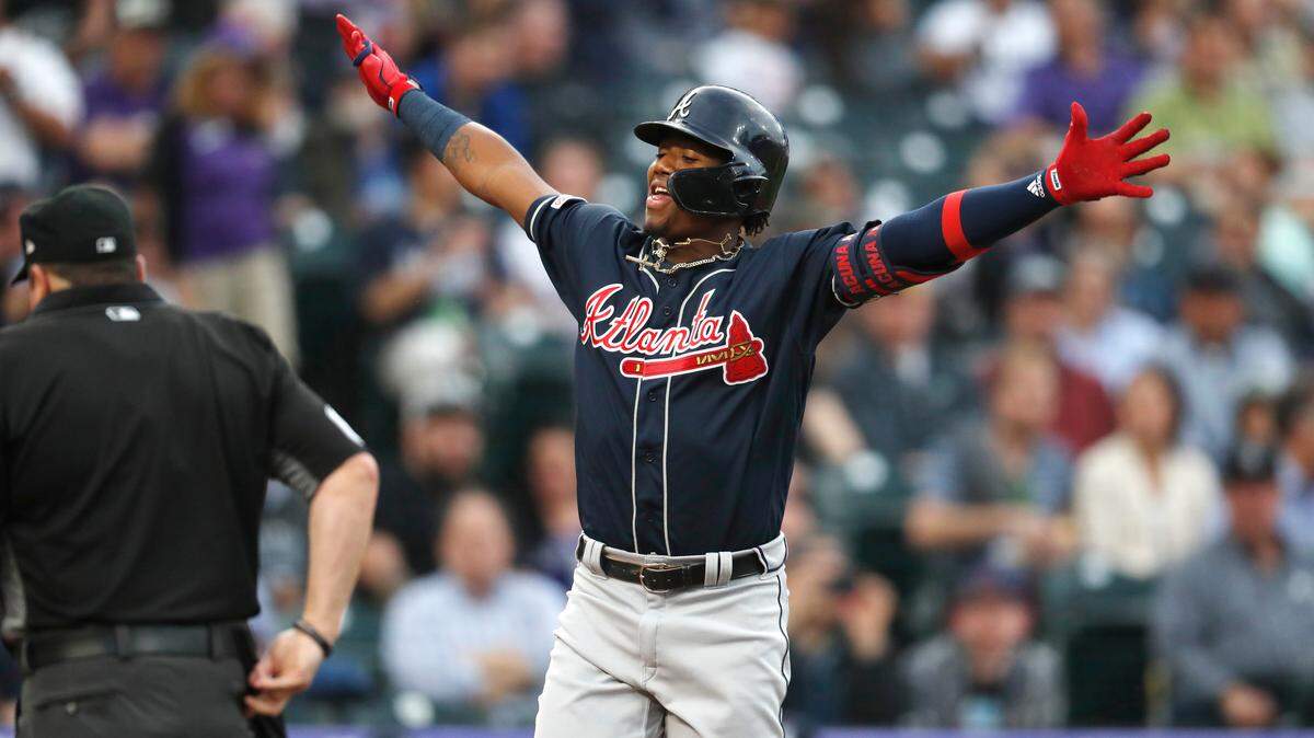 Atlanta Braves’ Ronald Acuna Jr. celebrates as he crosses home plate after hitting a solo home run off Colorado Rockies starting pitcher German Marquez during the second inning of a baseball game Tuesday, April 9, 2019, in Denver.