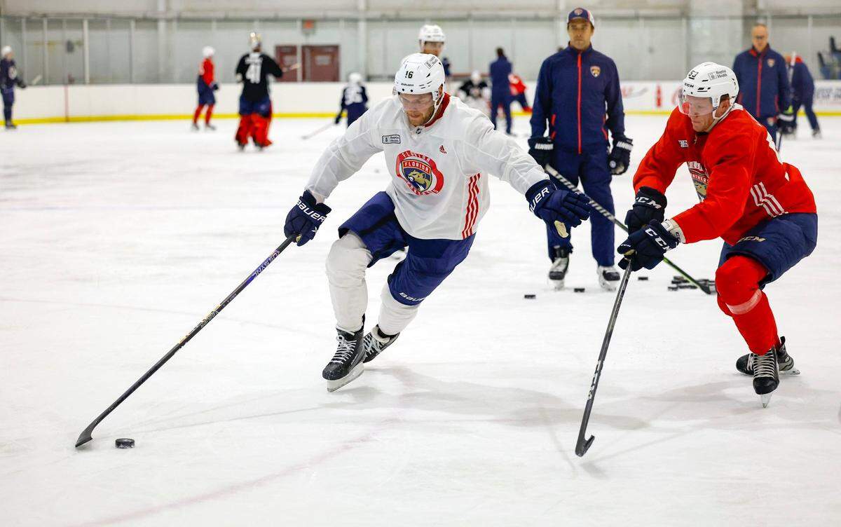 Florida Panthers Aleksander Barkov (16) drives the puck as John Ludvig (53) defends during practice drills at Florida Panthers IceDen in Coral Springs, Florida on Thursday, September 21, 2023.
