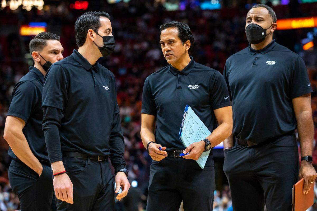 Miami Heat coach Erik Spoelstra speaks with the rest of the coaching staff during the first half of an NBA game at FTX Arena in Miami on Saturday, February 12, 2022.