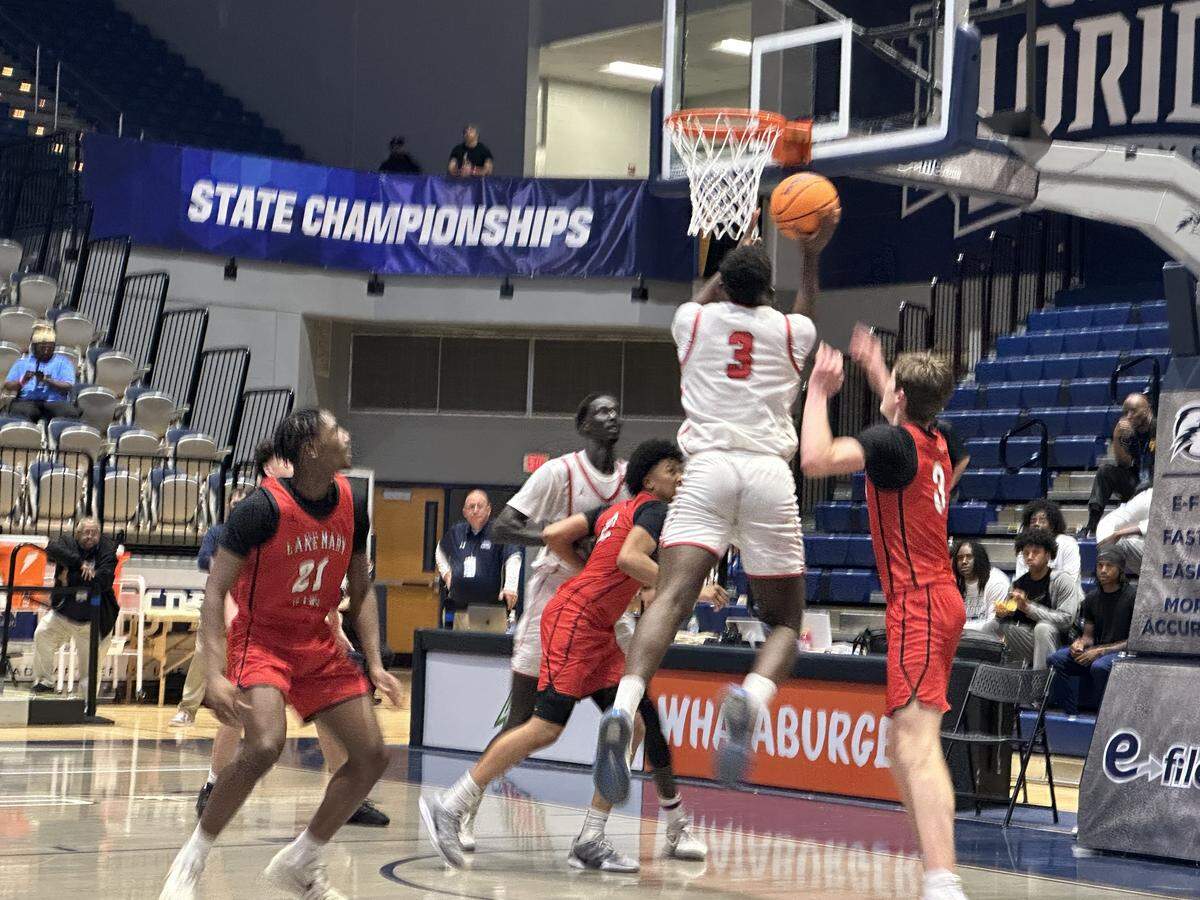 Columbus forward Jordan Fisher goes up for a shot during the Class 7A boys’ basketball state semifinal on Friday at UNF Arena in Jacksonville, Fla.