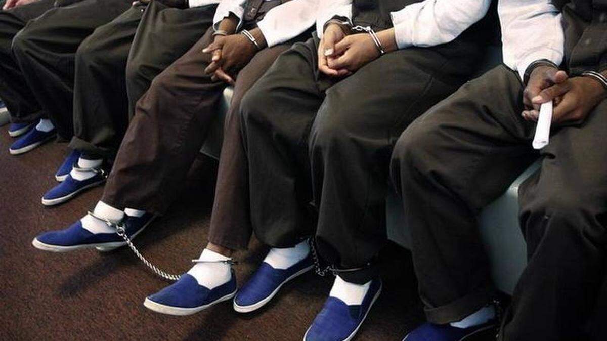 A group of juveniles to handcuffed as they wait to appear in court.