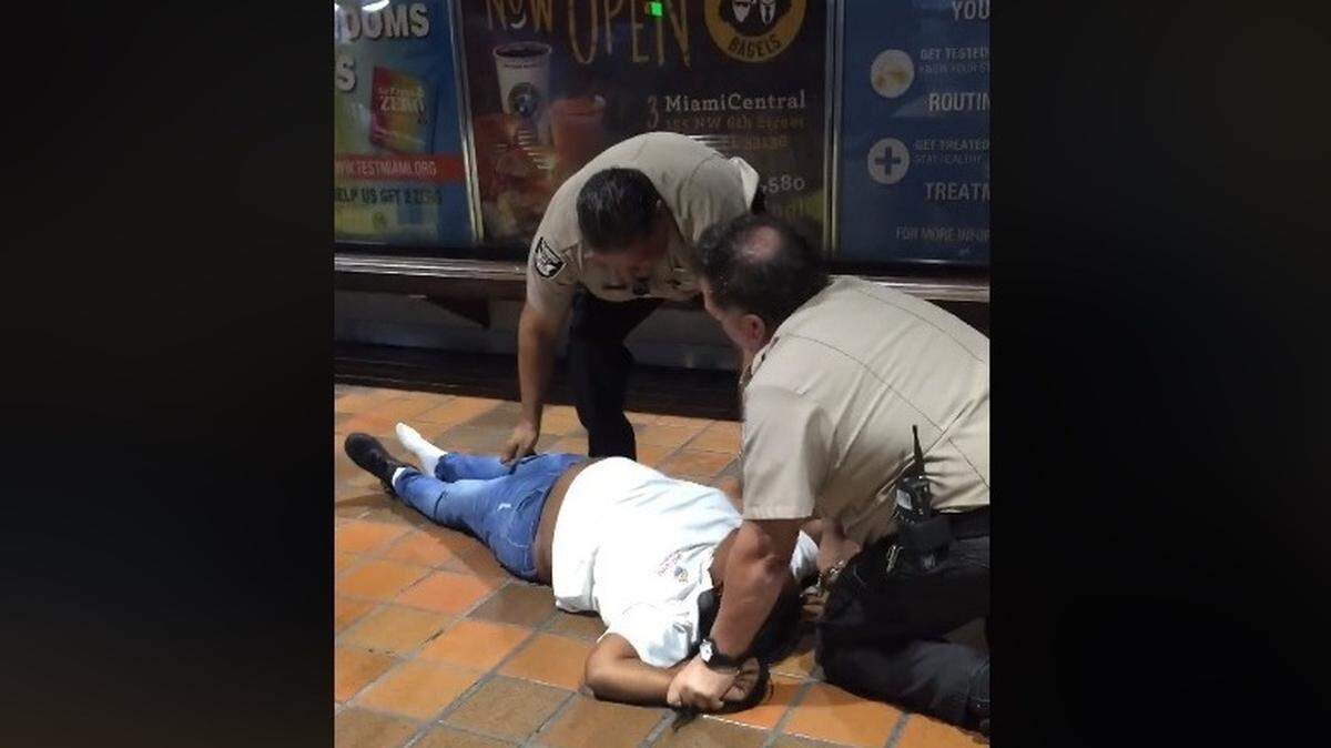 A screen grab from Ingrid Love’s Facebook video post. In the clip, a woman, who was seated on a bench at Metrorail’s Government Center station on the night of Feb. 11, 2019 is forcibly removed and slammed and pinned to the ground by three guards from U.S. Security Associates. The firm is contracted by Miami-Dade County to provide security for Metrorail. The men are no longer contracted to provide services for the county, a Miami-Dade spokeswoman said.