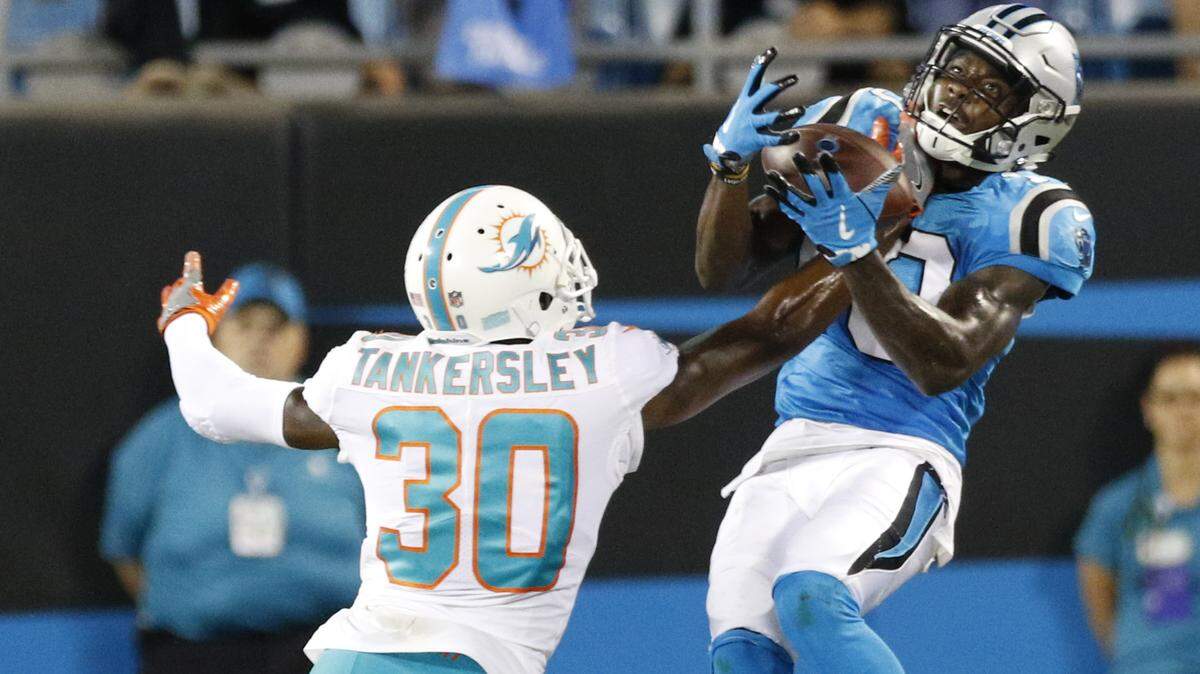 Carolina Panthers’ Curtis Samuel (10) catches a pass as Miami Dolphins’ Cordrea Tankersley (30) defends in the second half of a preseason NFL football game in Charlotte, N.C., Friday, Aug. 17, 2018. (AP Photo/Nell Redmond)