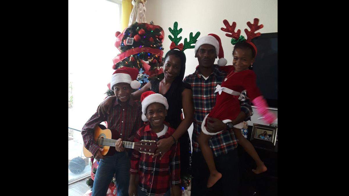 Damion Solan and Colett Solan with their three children in Lauderhill during a previous Christmas season.