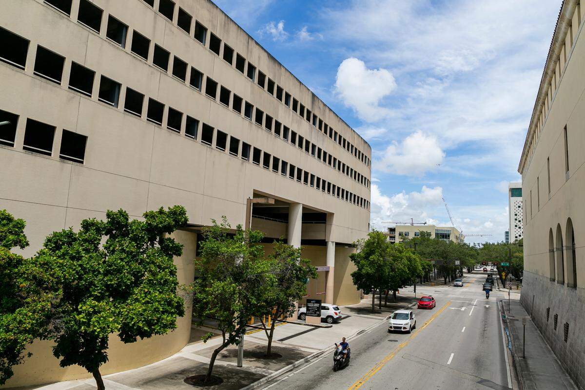The fortress-like Miami-Dade Cultural Center, right, is connected to a county parking garage, left, by a pedestrian bridge across Northwest Second Avenue downtown.
