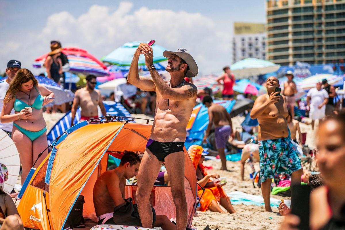Beach goers follows aircraft flying over South Beach during the Hyundai Air & Sea Show 2022 in Miami Beach. on Saturday May 28, 2022,