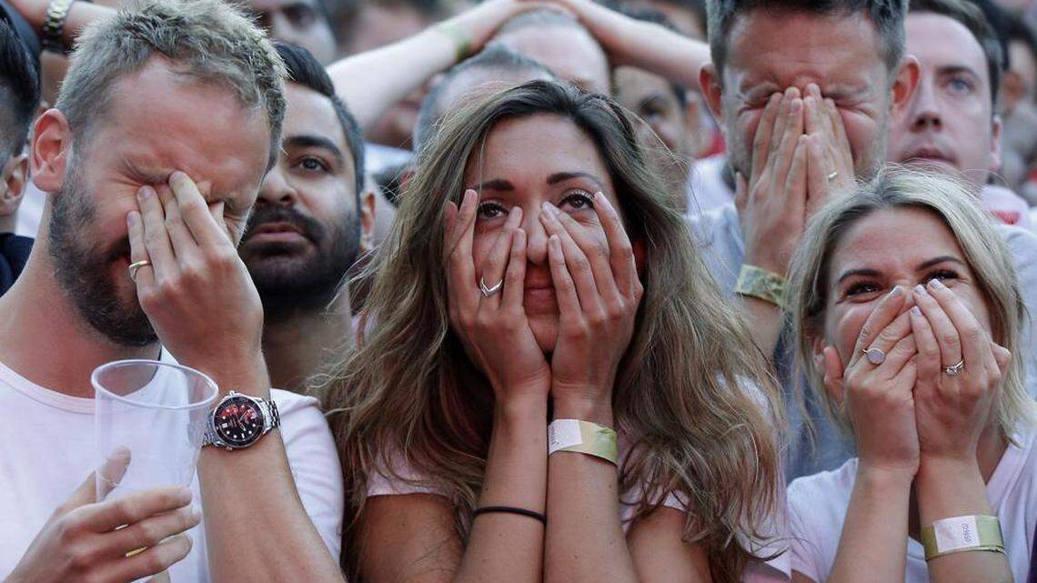 England soccer fans watching a live broadcast on a big screen react after Croatia scores its first goal in the semifinal match between Croatia and England at the 2018 soccer World Cup.