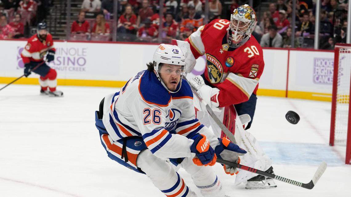 Edmonton Oilers center Mattias Janmark (26) chases the puck as Florida Panthers goaltender Spencer Knight defends during the first period of an NHL hockey game, Saturday, Nov. 12, 2022, in Sunrise, Fla. (AP Photo/Lynne Sladky)