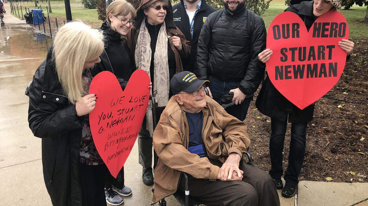 Family and friends greet Stuart Newman outside the World War II Memorial in Washington, D.C.