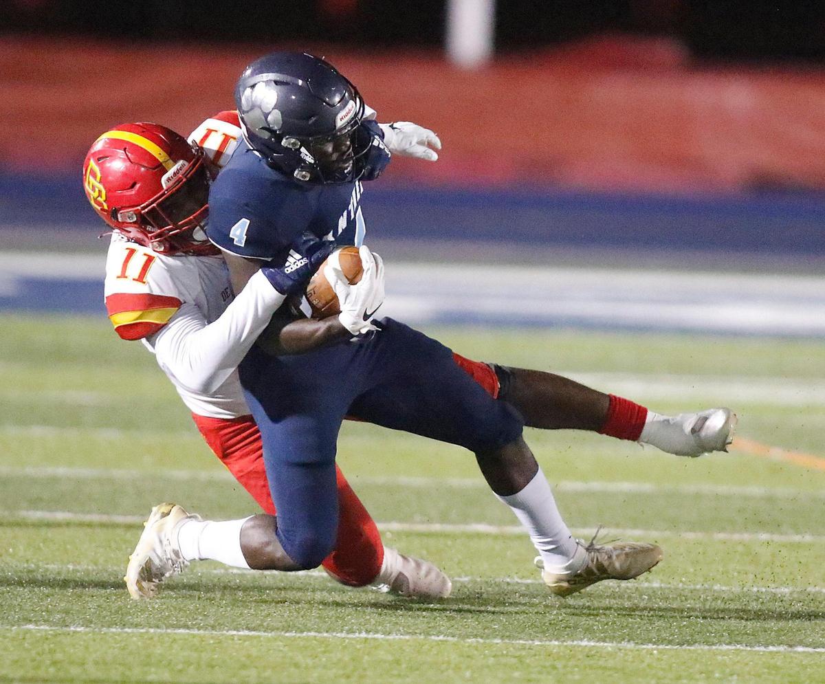 Palmetto Panthers wide receiver Bobby Bussey-Golden (4) is taken down by Deerfield Beach Bucks linebacker Keith Thompson (11) during the Class A 8 Regional semifinal football game on Thursday, November 18, 2021 Tropical Park Stadium. Andrew Uloza / for THE MIAMI HERALD