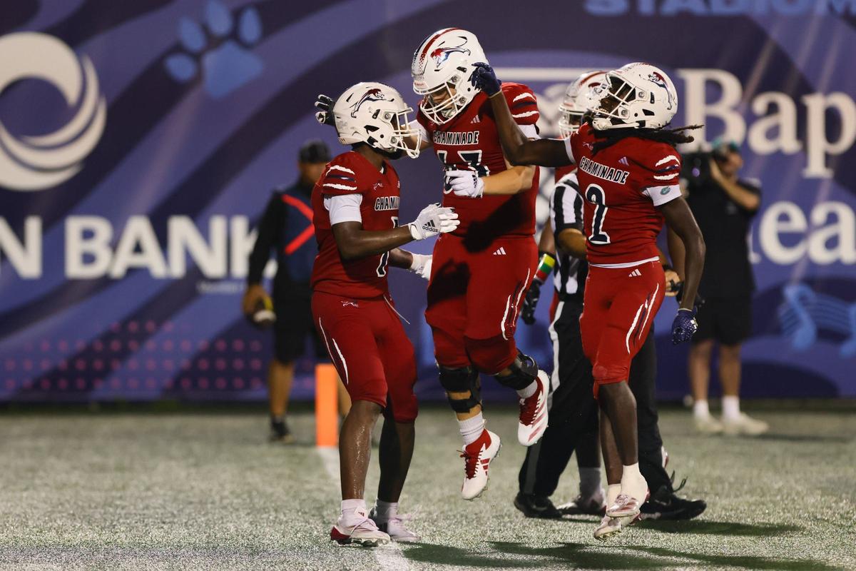 Chaminade-Madonna Lions Derrek Cooper (1) celebrates with offensive lineman Massimo Lucero (63) after scoring a touchdown against the St. Thomas Aquinas Raiders during the third quarter of a high school football game at Pitbull Stadium at Florida International University in Miami, Florida, Friday, October 11, 2024.