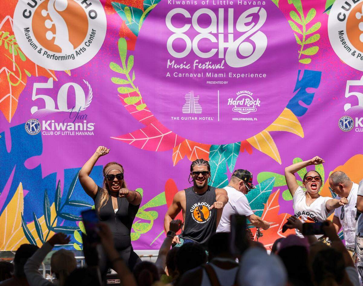 Accompanied by other festival goers, Steven Bartumeu, center, takes the stage and leads the crowd in dance between performances.