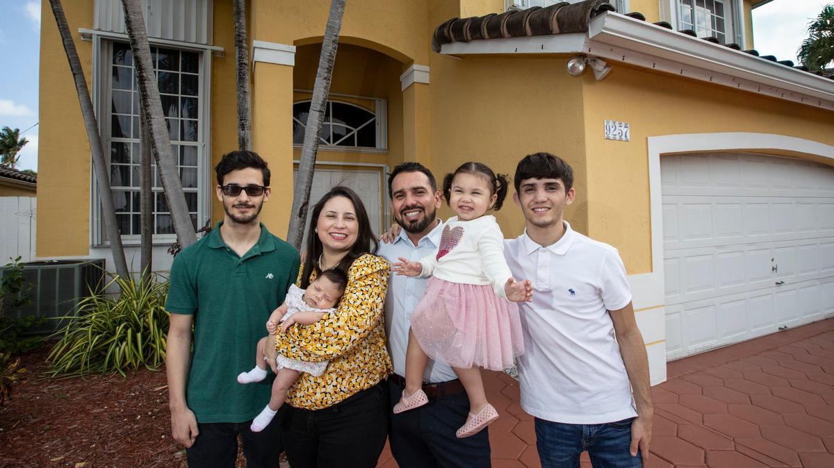 From left, Angel Madriz, 18, Joan Madriz holding 2-week-old Julia Madriz, Ahmed Madriz holding 2-year-old Emma Madriz, and Anthony Madriz, 17, at their home on Saturday, Jan. 18, 2020. Ahmed Madriz is an Iraq War veteran who bought a home in West Kendall using assistance from the VA Home Loan program.