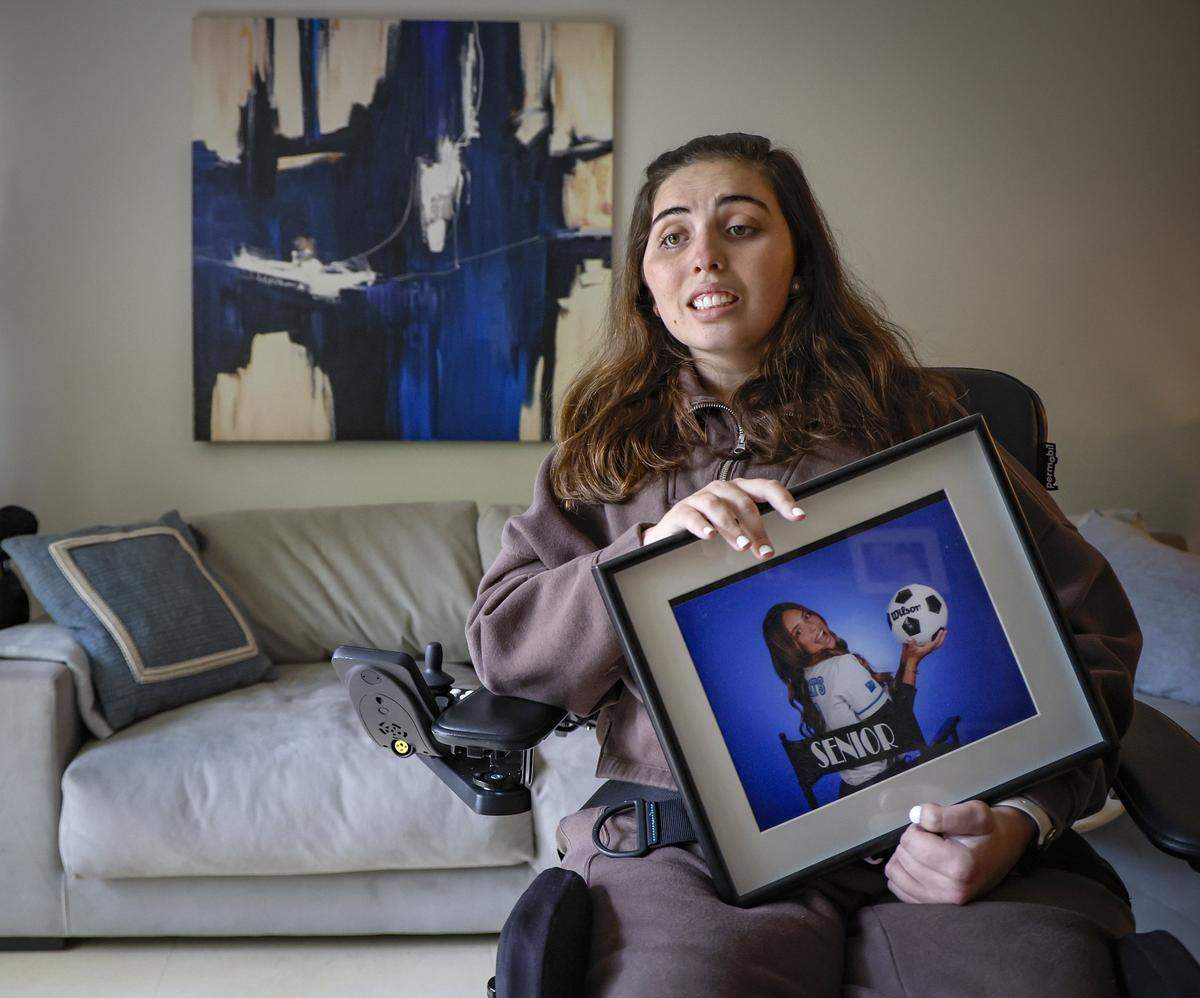 Katerina ‘Katy’ Puig holds a Our Lady of Lourdes Academy senior year portrait at her home in Miami, FL, on Wednesday, October 15, 2025. Puig is still recovering from catastrophic injuries she recieved in a Boca Chita Key boat crash. Puig was riding on Doral real estate developer George Pino’s boat with 10 of their friends when he crashed the 29-foot Robalo into a fixed channel marker at nearly 50 mph, ejecting everyone from the vessel, on September 4, 2022. Nicklaus Children's Hospital will be honoring her recovery journey Saturday at the hospital system's 18th Annual Diamond Ball Gala.