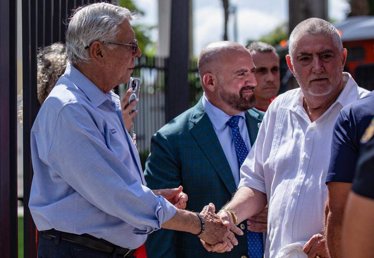 Victim of the Temple Court Apartment fire is greeted by Commissioner Manolo Reyes after arriving by trolley at the Jose Marti Gym on 434 SW and 3rd Ave. to receive aid on Monday, June 10, 2024 in Miami, Fla.