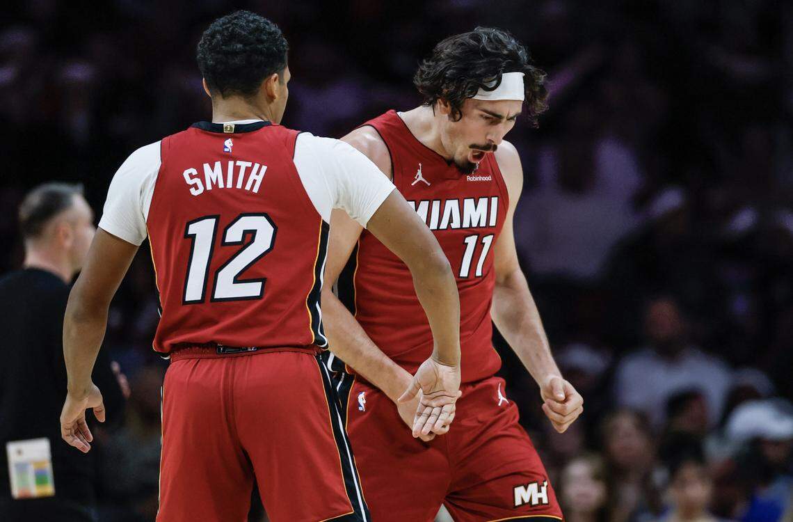 Miami Heat forward Jaime Jaquez Jr. (11) and guard Dru Smith (12) react after Jaquez Jr. scores against the Toronto Raptors during the first half of their NBA basketball game at Kaseya Center in Miami on December 23, 2025.