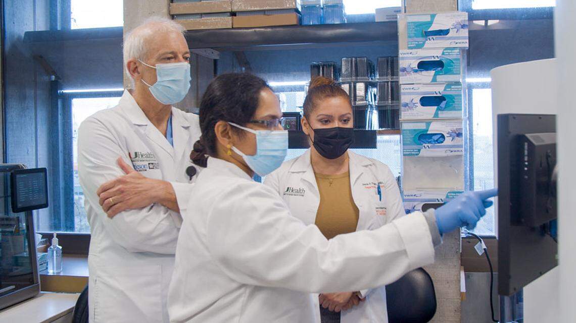 University of Miami researchers have been tracking SARS-CoV-2 variants through genomic sequencing. In this photo, Dr. David Andrews, associate professor at UM’s Miami Miller School of Medicine, reviews data with senior medical technologist Ranjini Valiathan and Paola Pagan, executive director of laboratory operations.
