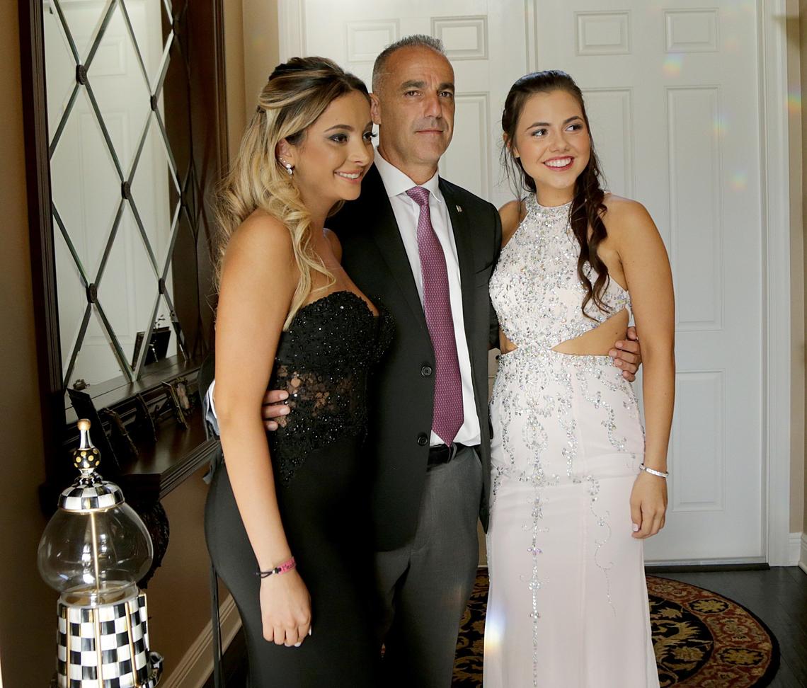 Andrew Pollack, father of Meadow Pollack, posed with his daughter's best friends Nicolette Miciotta, left, and Carley Ogozaly as they get ready for the prom Saturday, May 5, 2018, at Marjory Stoneman Douglas High. Meadow, a senior, was one of 17 students and educators killed in the Feb. 14, 2018, mass shooting at the Parkland school.